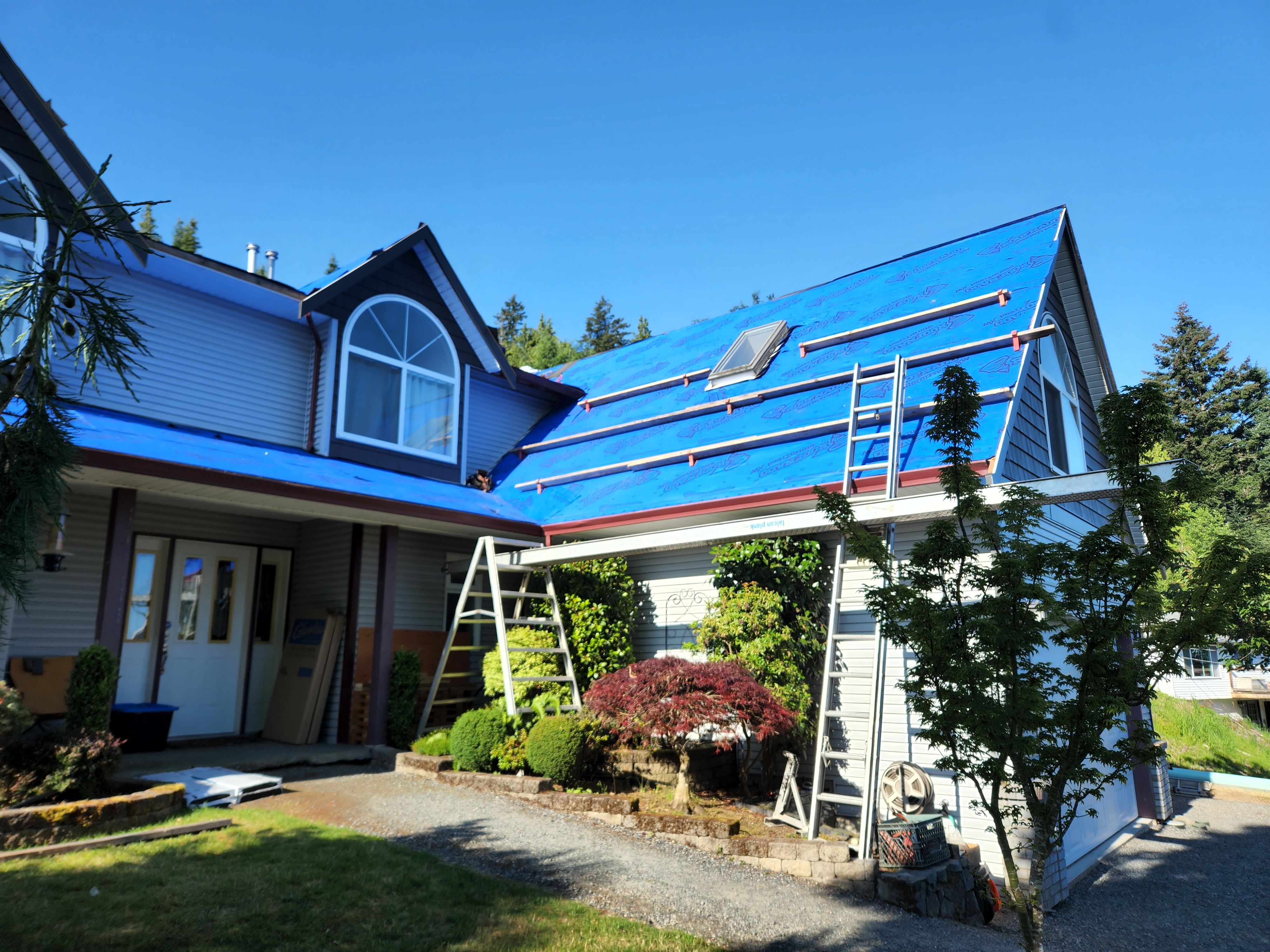 Residential roof replacement in progress with underlayment installed